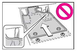 Subaru Solterra checking floor mat position before driving